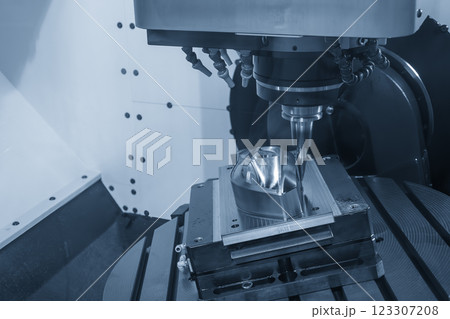 The 5-axis machining center cutting mold parts with solid barrel end mill tool in the light blue scene. The 5-axis machining center cutting mold parts with solid barrel end mill tool in the light blue scene. 123307208