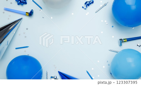Concept of festive birthday celebrations. Birthday attributes colorful balloons, party hats, candles, confetti Concept of festive birthday celebrations. Birthday attributes colorful balloons, party hats, candles, confetti 123307395