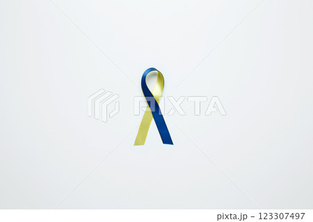 A yellow and blue awareness ribbon, symbolizing World Down Syndrome Day 123307497