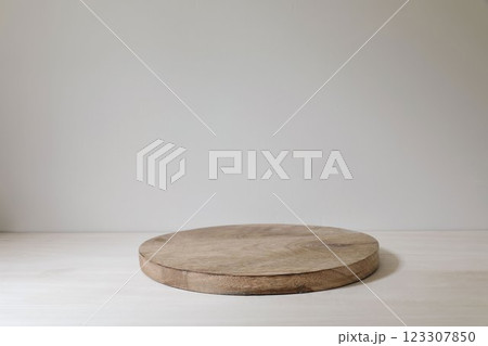 Wooden round product podium base. Platform board on white table. Beige wall background. Product template display, presentation. Natural scene for cosmetic advertising mockup. Neutral pedestal. 123307850