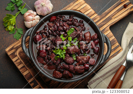 Brazilian feijoada with black beans, sausage, and meat in a pot, top view 123308052