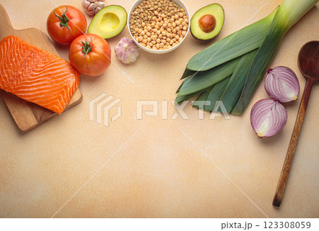 Fresh salmon, avocado, vegetables, legumes, and wooden spoon for cooking healthy meal top view, space for text Fresh salmon, avocado, vegetables, legumes, and wooden spoon for cooking healthy meal top view, space for text 123308059