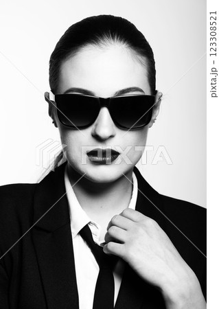 Woman portrait with black suit and sunglasses 123308521