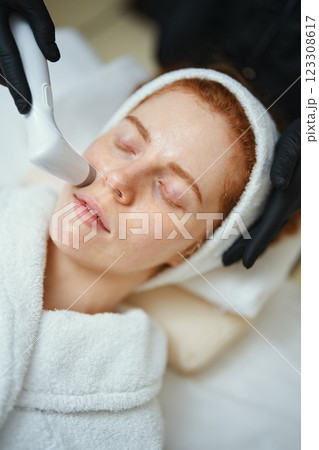 Skincare treatment session at a wellness center with a relaxed client Skincare treatment session at a wellness center with a relaxed client 123308617