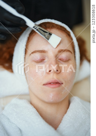 Woman receiving facial treatment in spa during daytime session 123308618
