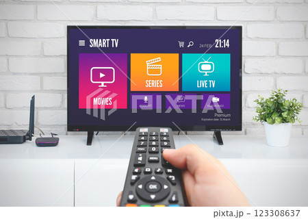 Man watching TV, remote control in hand 123308637