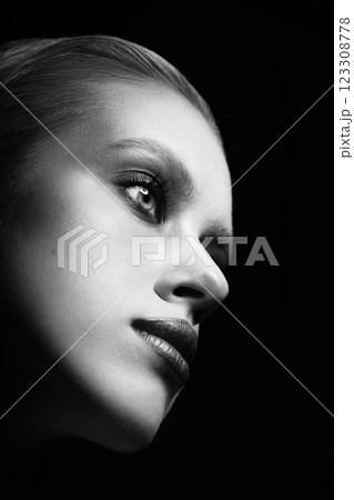 Close-up studio portrait of beautiful woman with fancy make-up in black background 123308778