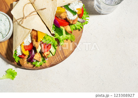 Greek chicken souvlaki wraps 123308927