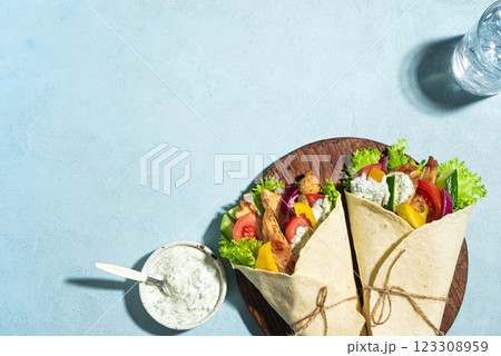 Greek chicken souvlaki wraps with vegetables Greek chicken souvlaki wraps with vegetables 123308959