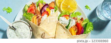 Greek chicken souvlaki or gyro wrap 123308960