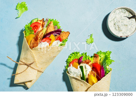 Greek chicken gyro wraps on blue background Greek chicken gyro wraps on blue background 123309000