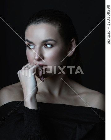 Beautiful woman with dark hair and blouse close-up studio portrait 123309299