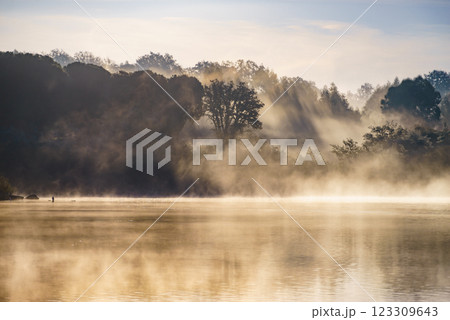 Morning fog over autumn lake water Morning fog over autumn lake water 123309643