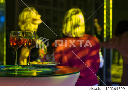 Glasses of wine at festive party with blurred people dancing in background 123309809