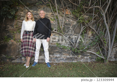 Chefs posing holding hands in front of stone wall with vines Chefs posing holding hands in front of stone wall with vines 123309944