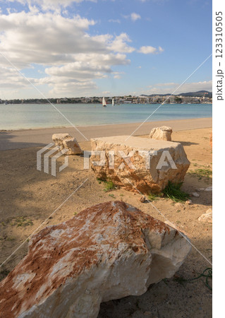large rocks, calm waters and a city 123310505