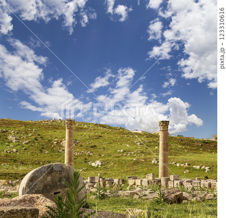 Roman ruins (against the background of a beautiful sky with clouds) in the Jordanian city of Jerash (Gerasa of Antiquity), capital and largest city of Jerash Governorate, Jordan Roman ruins (against the background of a beautiful sky with clouds) in the Jordanian city of Jerash (Gerasa of Antiquity), capital and largest city of Jerash Governorate, Jordan 123310616