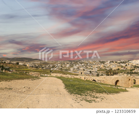 Roman ruins (against the background of a beautiful sky with clouds) in the Jordanian city of Jerash (Gerasa of Antiquity), capital and largest city of Jerash Governorate, Jordan 123310659