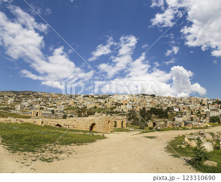 Roman ruins (against the background of a beautiful sky with clouds) in the Jordanian city of Jerash (Gerasa of Antiquity), capital and largest city of Jerash Governorate, Jordan Roman ruins (against the background of a beautiful sky with clouds) in the Jordanian city of Jerash (Gerasa of Antiquity), capital and largest city of Jerash Governorate, Jordan 123310690