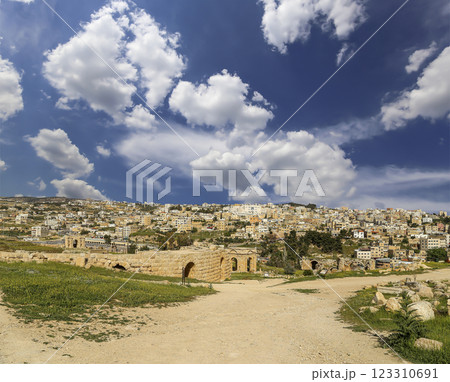 Roman ruins (against the background of a beautiful sky with clouds) in the Jordanian city of Jerash (Gerasa of Antiquity), capital and largest city of Jerash Governorate, Jordan Roman ruins (against the background of a beautiful sky with clouds) in the Jordanian city of Jerash (Gerasa of Antiquity), capital and largest city of Jerash Governorate, Jordan 123310691