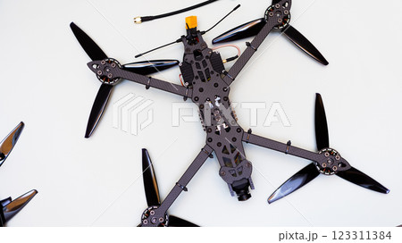 FPV drone in production on white background. FPV drone in production on white background. 123311384