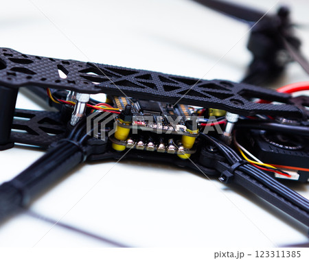 FPV drone in production on white background. FPV drone in production on white background. 123311385