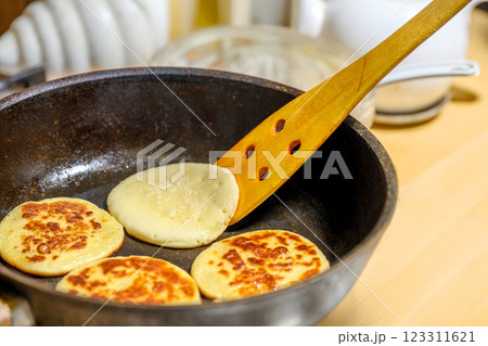 Delicious and Fluffy Pancakes Cooking in a Skillet on the Stovetop with Buttery Goodness Delicious and Fluffy Pancakes Cooking in a Skillet on the Stovetop with Buttery Goodness 123311621