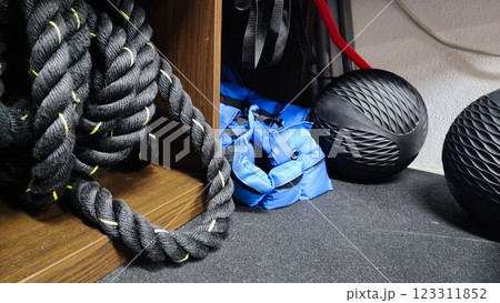 Set of fitness inventory on floor near brick wall. Space for text Set of fitness inventory on floor near brick wall. Space for text 123311852