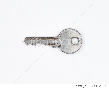 A worn silver key with scratches isolated on white background 123312503