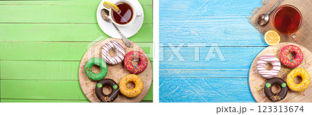 glazed donuts with a cup of tea on a green wooden background with copy space for your text. Top view 123313674