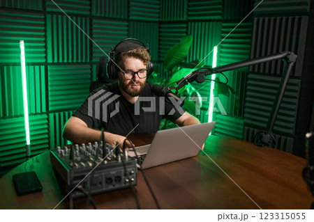 Handsome man radio DJ hosting a radio show, entertainment and communication concept 123315055