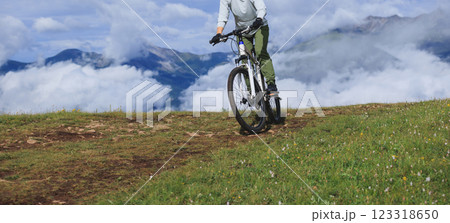 Riding mountain bike on beautiful mountain top Riding mountain bike on beautiful mountain top 123318650
