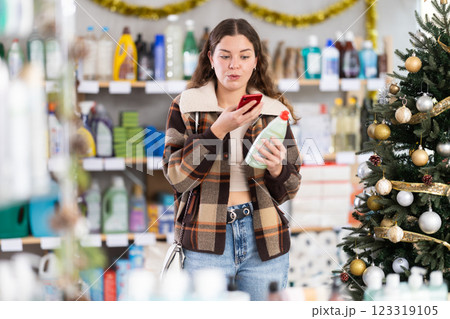 Young woman scanning qr code for dishwashing Young woman scanning qr code for dishwashing 123319105