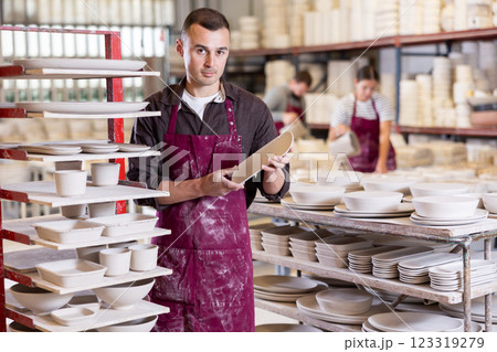 Young man posing with ceramic blanks 123319279