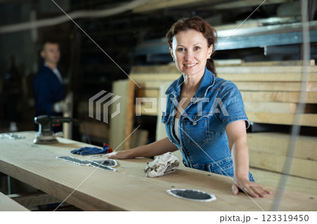 Adult woman posing with oak plank Adult woman posing with oak plank 123319450