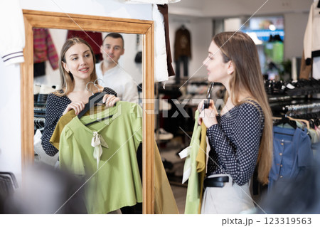 Couple young woman and young man choosing blouse Couple young woman and young man choosing blouse 123319563