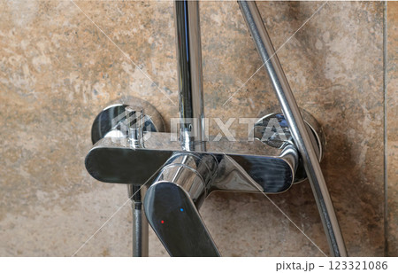 Clean faucet in shower stall on marble modern dark tile after cleaning. Cleanliness in the bathroom. Taking care of house and order. 123321086