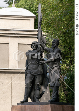 Krasnoyarsk, Russia - May 09 2024: A soldier in a helmet with a cloak holds a victory sword in his hands. Krasnoyarsk, Russia - May 09 2024: A soldier in a helmet with a cloak holds a victory sword in his hands. 123321251