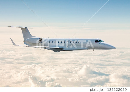 White business jet flies in the air above the clouds White business jet flies in the air above the clouds 123322029