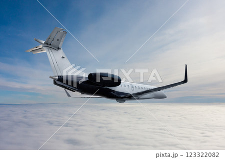 Modern luxury private jet flies in the air above the clouds Modern luxury private jet flies in the air above the clouds 123322082