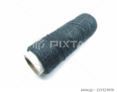 A picture of black thread roll on white background A picture of black thread roll on white background 123323656