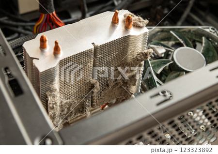 Dusty CPU cooler inside a computer. Neglected maintenance, overheating risk, and potential hardware damage. Dusty CPU cooler inside a computer. Neglected maintenance, overheating risk, and potential hardware damage. 123323892