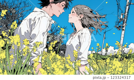 菜の花畑でデートをしている若いカップル