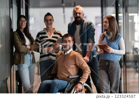 A businessman with disability in a wheelchair is surrounded by supportive colleagues in a modern office, showcasing the strength of teamwork, inclusivity, and empowerment in the face of challenges. A businessman with disability in a wheelchair is surrounded by supportive colleagues in a modern office, showcasing the strength of teamwork, inclusivity, and empowerment in the face of challenges. 123324587