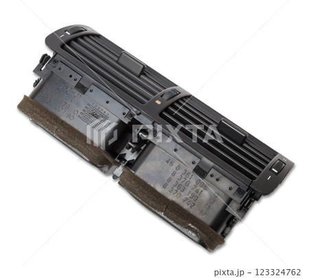 A close-up view of a part of the interior of a modern car with a view of the ventilation deflector of the heater for heating and cooling the passenger compartment. Used auto part catalog from junkyard A close-up view of a part of the interior of a modern car with a view of the ventilation deflector of the heater for heating and cooling the passenger compartment. Used auto part catalog from junkyard 123324762