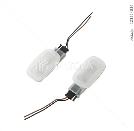 A pair of transparent plastic shades for illuminating the interior on a white isolated background in a photo studio - spare parts for repairing a car interior or for sale in a auto service 123324836