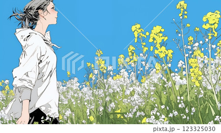 菜の花畑にいる若い女性