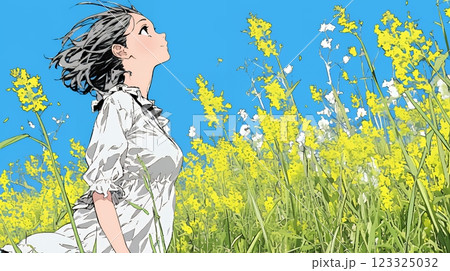 菜の花畑にいる若い女性
