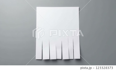 Simple paper cutting technique shown with strips created at the bottom of a blank sheet on a gray background Simple paper cutting technique shown with strips created at the bottom of a blank sheet on a gray background 123328373