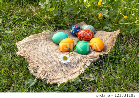 Easter eggs and a sackcloth bag on green grass. Easter eggs and a sackcloth bag on green grass. 123331185